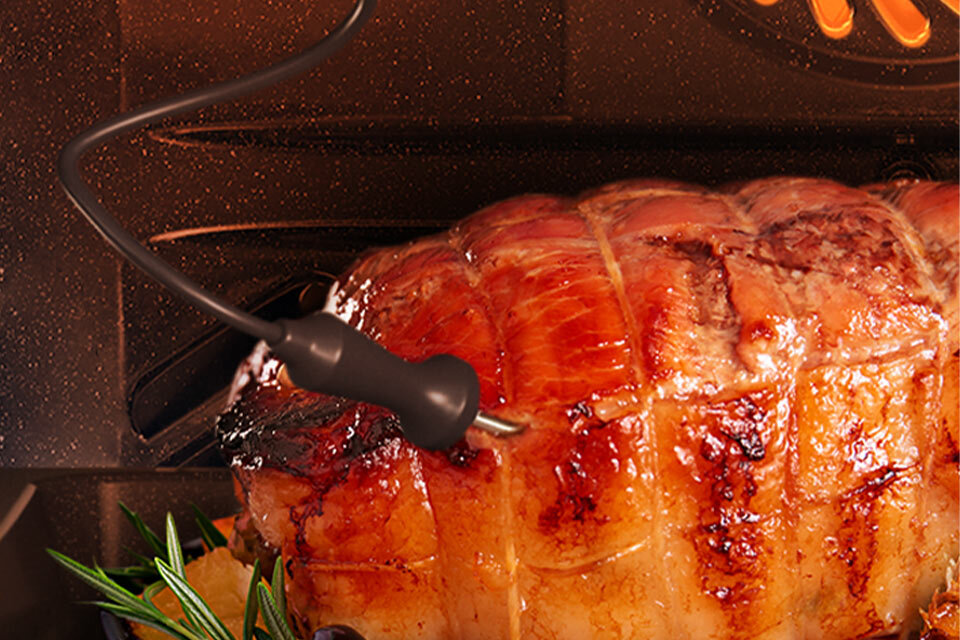 Zdjęcie pokazuje termosondę włożoną w kawałek soczystego i przypieczonego z zewnątrz mięsa